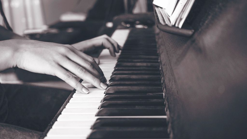 Close-up of a pianist’s hands on the keys during a lesson